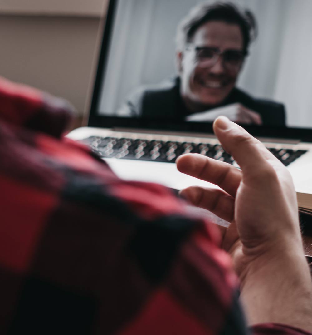 Two people engaged in a lively video-conference.